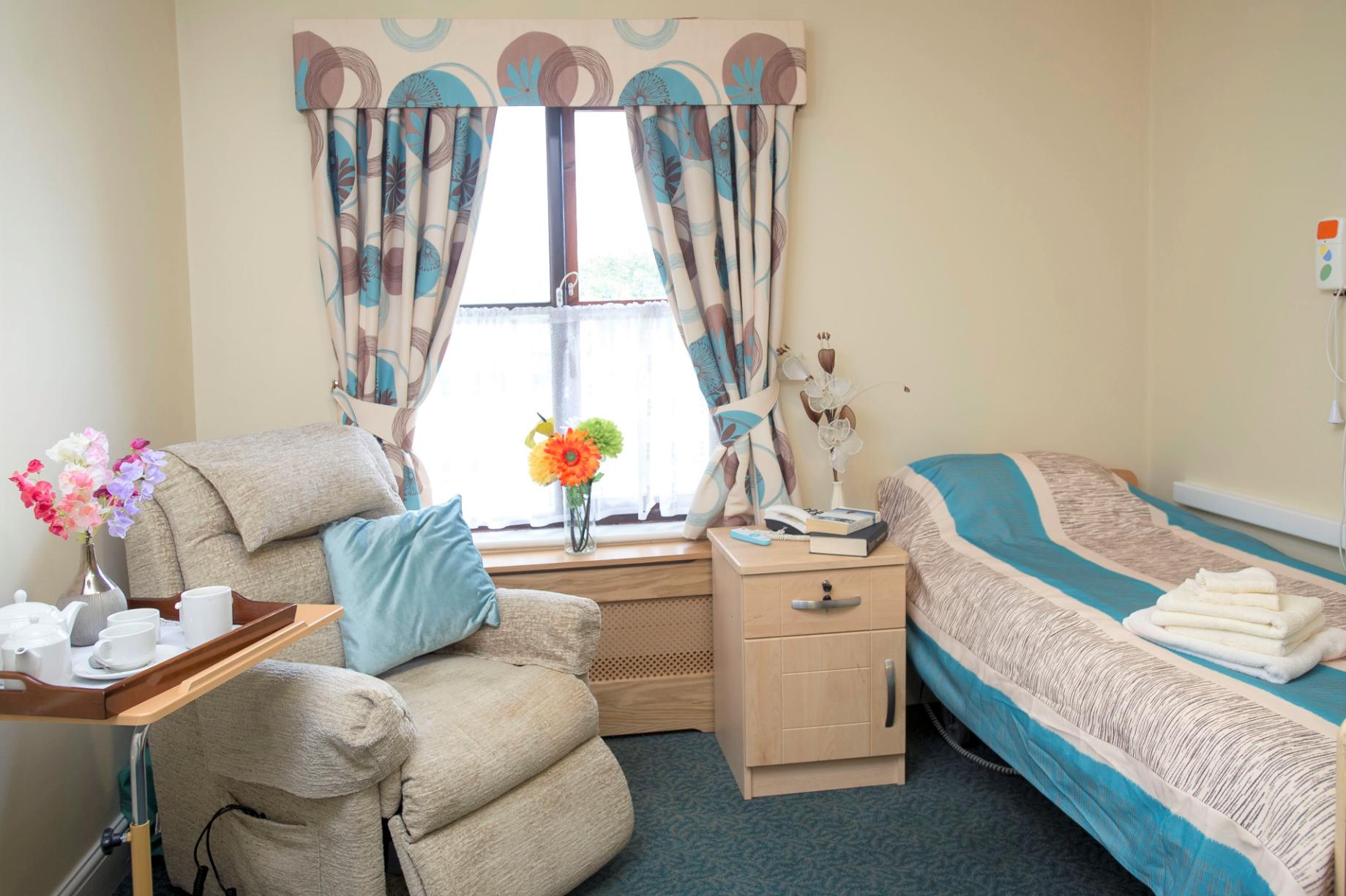 bedroom with blue bedding and matching curtains